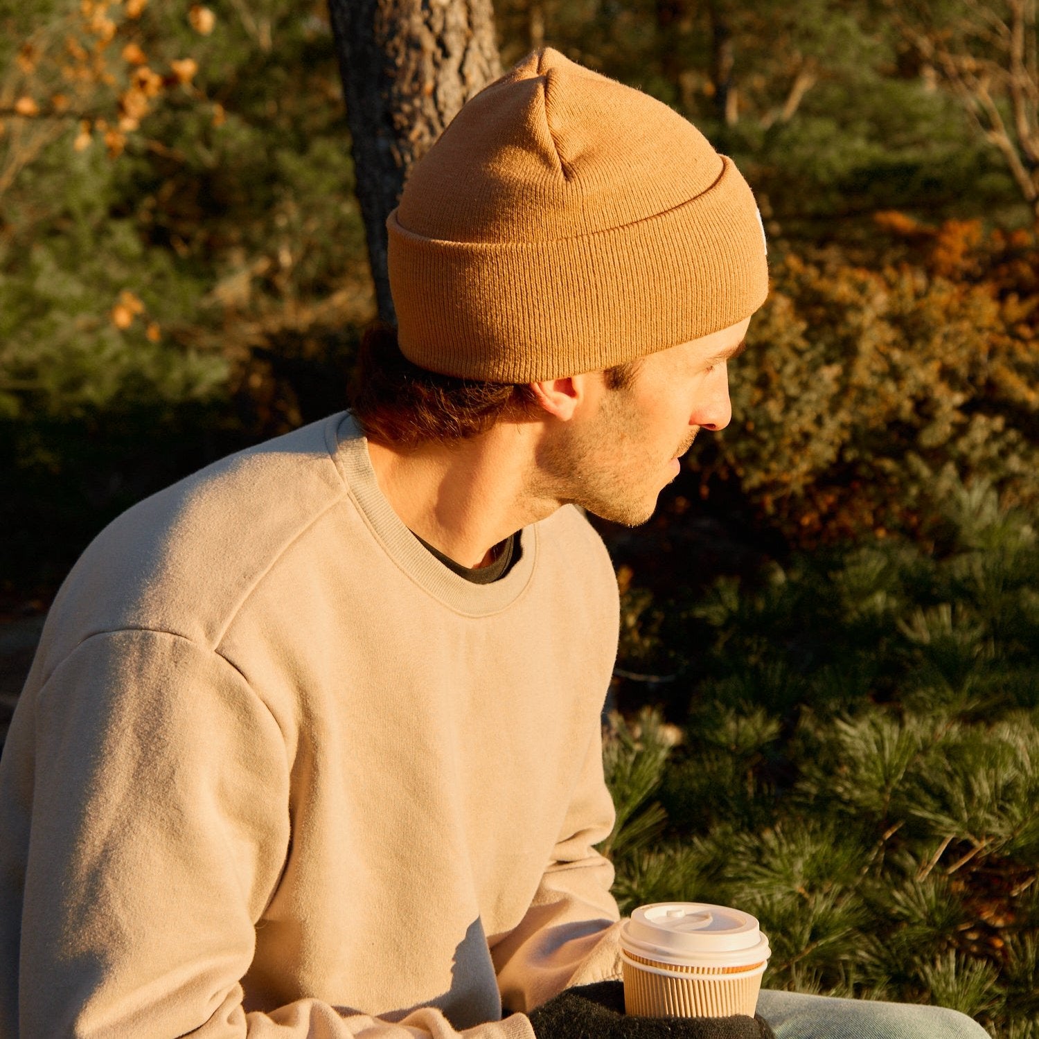 A man wearing a Camel Sailor Beanie looking off in the distance.